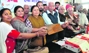 BJP workers show the iron articles collected by the Loh Sangrah Sahyog committee at Sector 33, Chandigarh, on Wednesday.