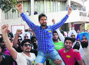 Supporters lift the newly announced president of the Student Organisation of Panjab University, Amninder Singh Mann, in Chandigarh on Wednesday.
