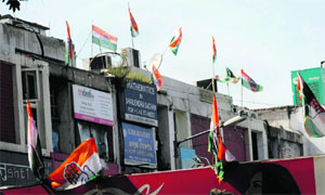 Flags of political parties displayed in a commercial area in Chandigarh.