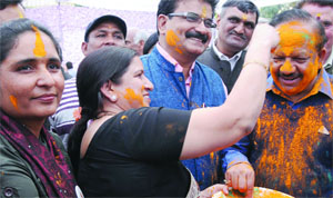 Delhi BJP president Harsh Vardhan and party leader Anita Arya smear colours on each other on the occasion of Holi Milan at the party office in New Delhi on Wednesday.