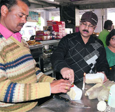 Food inspectors take samples of dairy products from a shop on Chandar Road on Dehradun on Wednesday.