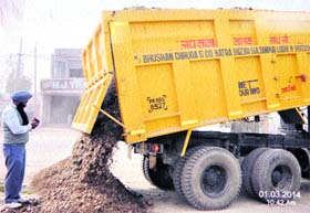 A posed picture allegedly got clicked by the Jalandhar MC authorities of unloading material at a road construction site to hoodwink the EC