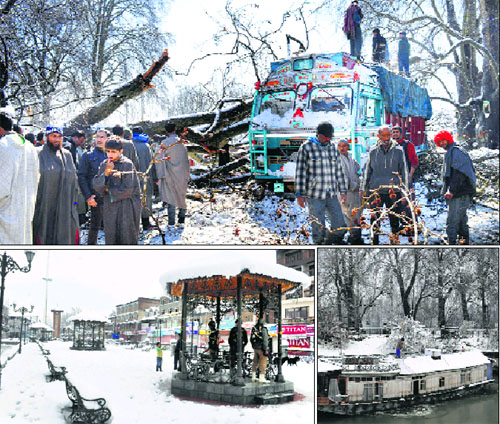People gather around a chinar tree which fell on a truck due to heavy snowfall in Anantnag district; a man clears snow from the roof of a houseboat in Srinagar city; and CRPF personnel take shelter near the Clock Tower at Lal Chowk in Srinagar on Wednesday.