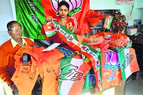 Poll fever: A shopkeeper displays publicity material in Jalandhar on Wednesday