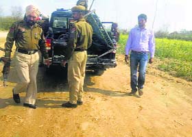Policemen remove belongings of those manning illegal barricades set up by the sand mafia near Bhanuha village in Ropar district on Wednesday