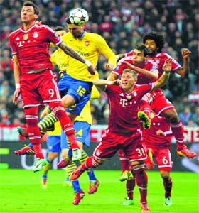Arsenals French striker Olivier Giroud (12) tries to score against Bayern Munich during their UEFA Champions League last 16 second leg match in Munich on Tuesday