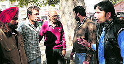 Superintendent Sushant Bhatia (right) argues with the agents operating illegally on the municipal corporations premises, in Amritsar on Thursday