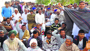 Villagers stage a dharna at Sultanpuria village in Sirsa on Thursday.