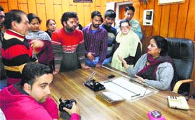 Protesters argue with Kangra Municipal Council chief Suman Verma at her office in Kangra on Thursday