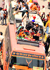 Putting their lives in danger, devotees engage a private bus from Amritsar to visit the Wadhabagh Singh Dera in Anandpur Sahib on Holla Mohalla in Amritsar on Friday
