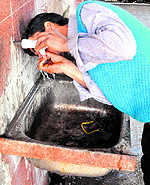 A visitor quenches his thirst from a tap at Amritsar railway station on Friday