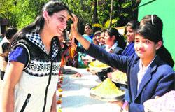 Students apply tilak during Holi celebrations at the GMSSS, Sector 46, Chandigarh, on Friday.