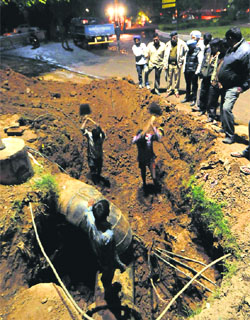 MC workers carry out repair work on a water pipeline at the Sector 26 roundabout on Friday night