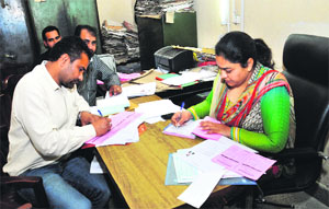 Staff of the Excise Department deal with applications for liquor vends in Jalandhar on Friday. 