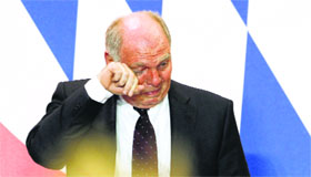 Uli Hoeness wipes tears as he accepts his mistake.