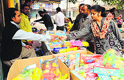 People purchase water guns for their children at a market in Amritsar on Friday