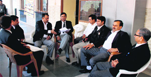 Lawyers sit outside the court room of Amit Verma, Civil Judge, at Panchkula District Court on Saturday. 