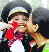 A girl cadet receives a kiss from her mother after a passing-out parade at Officers Training Academy in Chennai on Saturday.