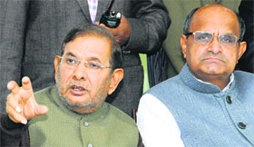 JD (U) president Sharad Yadav addresses a press meet in New Delhi as party leader KC Tyagi looks on.