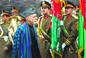 Afghanistan President Hamid Karzai arrives at the opening ceremony of the fourth year of Parliament in Kabul