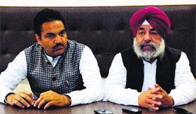 Sukhjinder Raj Singh Lalli Majithia (right) and District Congress Committee (Rural) president Gurjeet Singh Aujla address media persons in Amritsar on Sunday.