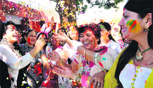Women celebrate Holi with flowers and colours in Chandigarh. 