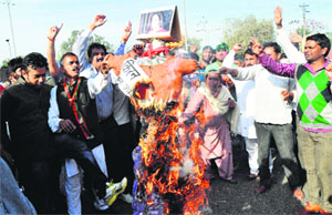 BJP workers burn an effigy of BJP Lok Sabha candidate Kirron Kher at the Transport light point in Sector 26, Chandigarh, on Sunday.