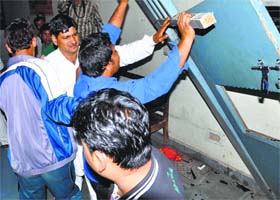 Supporters of BJP leader Naresh Malik ransack the party office in Rohtak