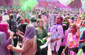 Girls play with colours on the occasion of Holi in Mandi on Sunday