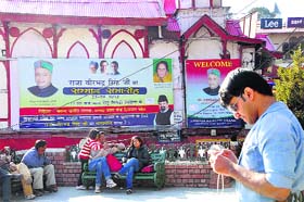 A hoarding displaying pictures of Chief Minister Virbhadra Singh and his wife, Congress candidate Pratibha Singh, makes a mockery of the model code of conduct on the Mall Road in Shimla on Sunday