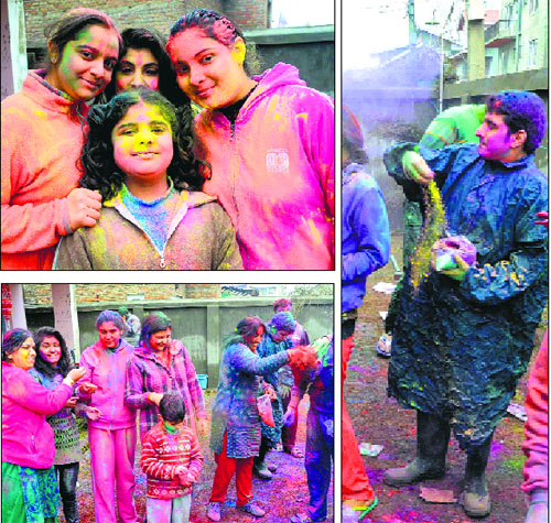 A group of people apply colours on each other as they celebrate Holi in Srinagar on Sunday. 