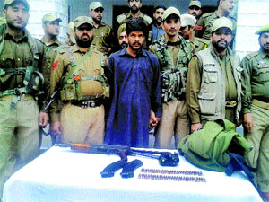Security personnel with the Hizb militant in Poonch district on Saturday.