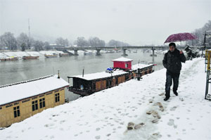 A man walks on the banks of the Dal Lake in Srinagar. 