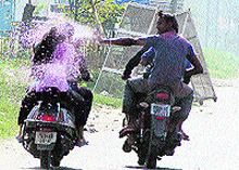 Jalandhar residents enjoy rain dance to celebrate Holi on Sunday; and (right) despite the formation of the anti-eve teasing cell by the police, girls bear the brunt on Holi