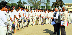 Aspirants listen to selectors during the trials conducted on the Arya College ground on Sunday