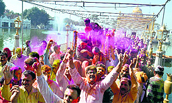 Devotees celebrate Holi at Durgiana Temple in Amritsar on Sunday