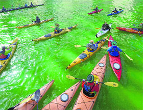 Kayakers float on the Chicago River after being dyed green ahead of the St. Patrick's Day parade in Chicago.