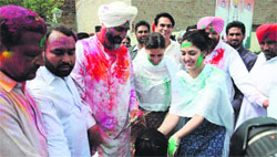 Manpreet Singh Badal celebrates Holi with his wife and daughter in Bathinda on Monday. Tribune photo