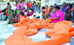 Women devotees make preperations for the annual Jhanda mela at Guru Ram Rai Shrine in Dehradun on Tuesday