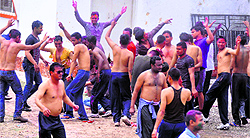 Policemen celebrate Holi by tearing each others clothes in Dehradun on Tuesday
