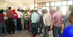 Applicants at the DTO office wait for counters to open as staff were busy in court work in Jalandhar on Tuesday