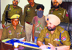 Accused in police custody during a press conference in Ludhiana