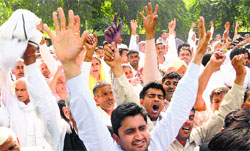 Haryana BJP Secretary Pradeep Sangwans supporters raise slogans outside party headquarters over denying him ticket from the Sonepat LS seat in New Delhi on Tuesday. Photo:Manas Ranjan Bhui