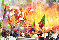 The blast that took place near a vehicle carrying Arun Jaitley and several BJP and SAD leaders in Amritsar on Tuesday; (below left) state BJP chief Kamal Sharma pours water on Jaitleys hand; and (right) minister Anil Joshi who was injured. Tribune photo
