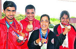 Akshit Kalia, Jatin Kashyap, Nancy and Priya show their medals won during the National Athletics Meet for Mentally Challenged Children