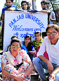 Gul Panag, Aam Aadmi Party candidate for the Chandigarh Lok Sabha seat, sits with students during their protest at Panjab University on Wednesday