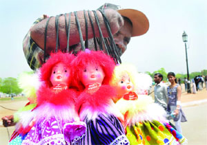 A differently abled hawker earns his living at India Gate in New Delhi on Wednesday