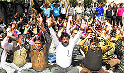 Members of the Coordination Committee of the Estates Employees Association protest in Jammu on Wednesday