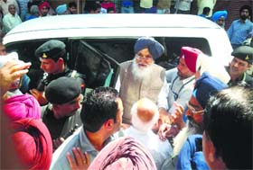 Chief Minister Parkash Singh Badal llistens to protesting traders in Faridkot on Wednesday