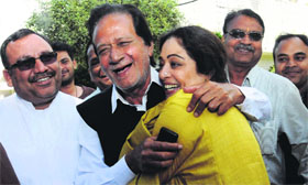 Former Union Minister Harmohan Dhawan hugs BJP nominee Kirron Kher at his residence in Sector 9, Chandigarh, on Thursday.